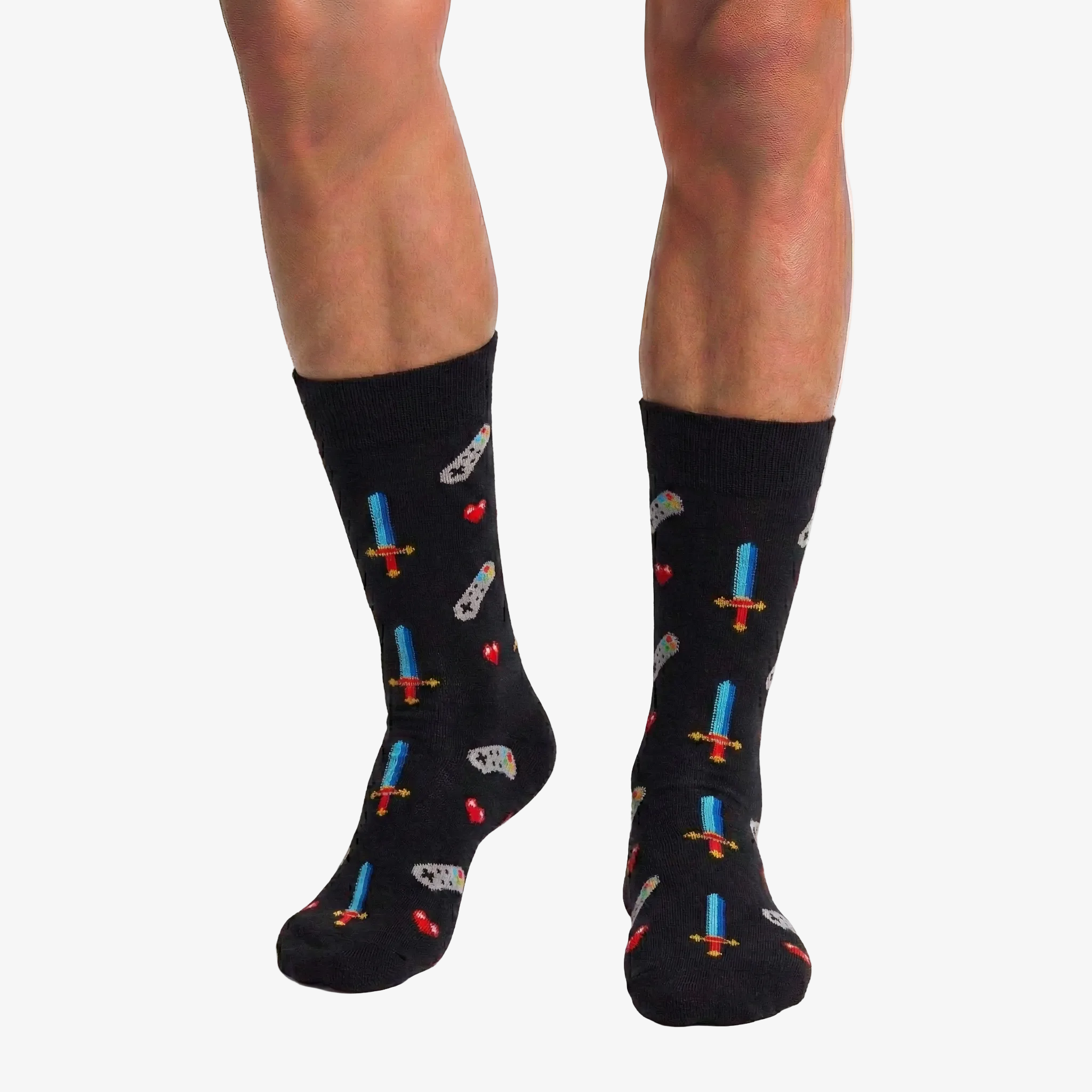 Black socks with colorful retro video game patterns worn by a person on a white background