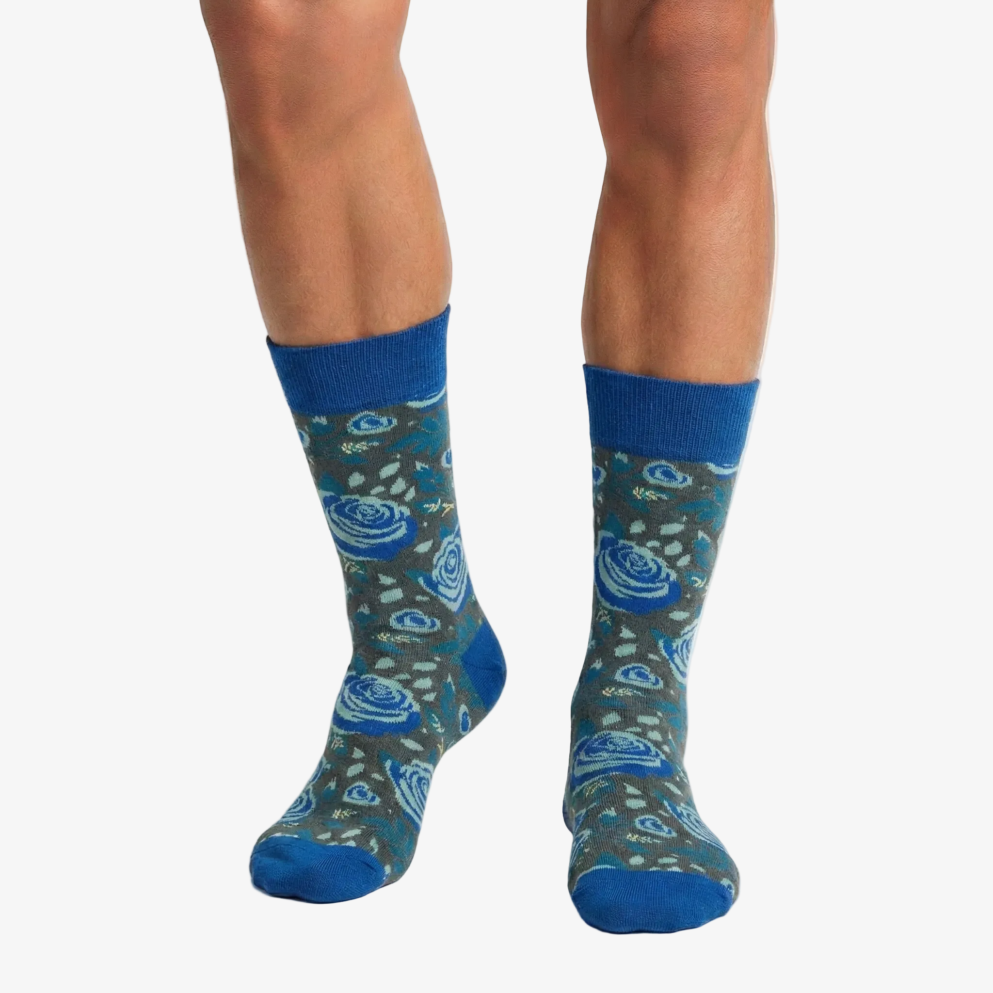 Blue patterned socks worn by a person on a white background
