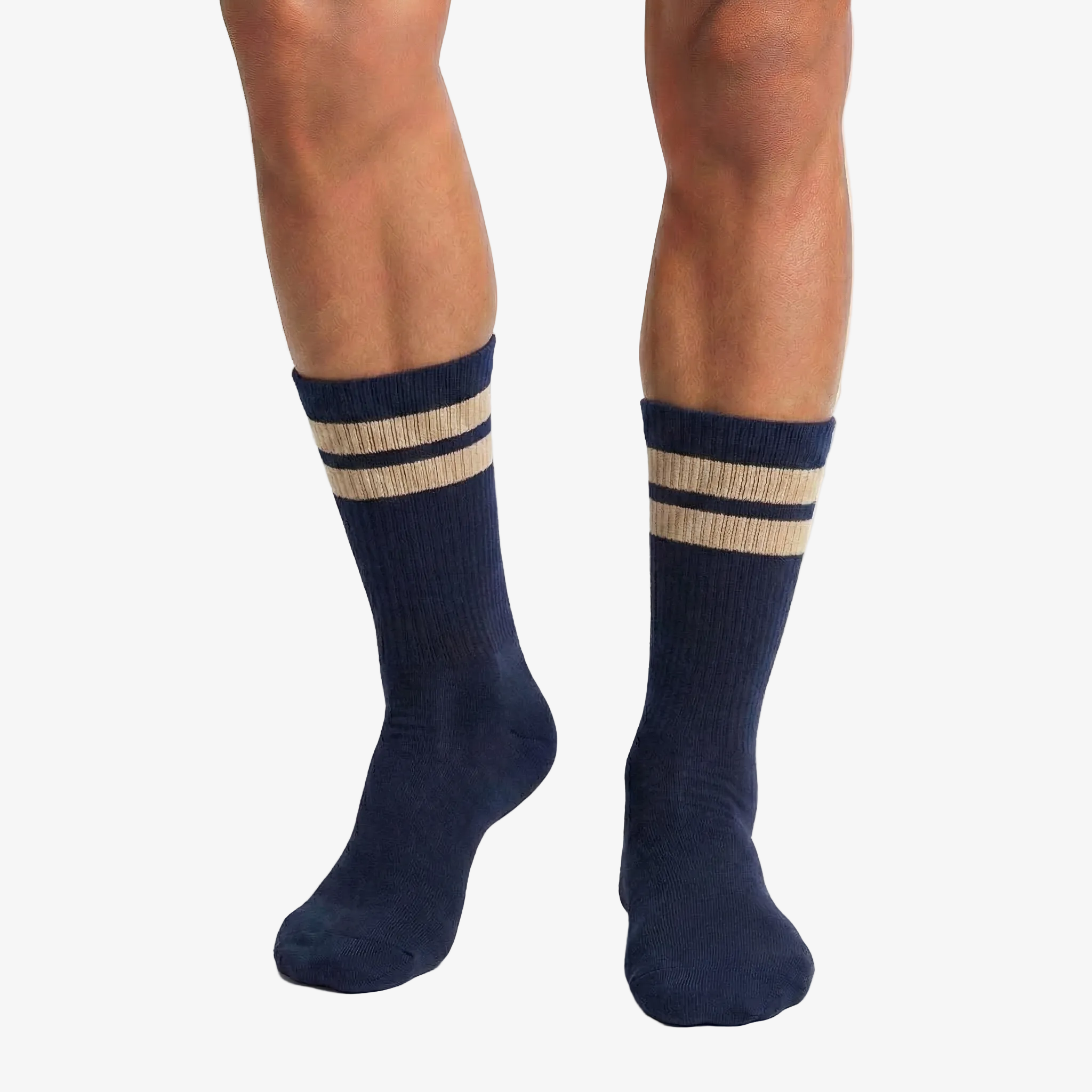 Navy socks with beige stripes worn by a person on a white background